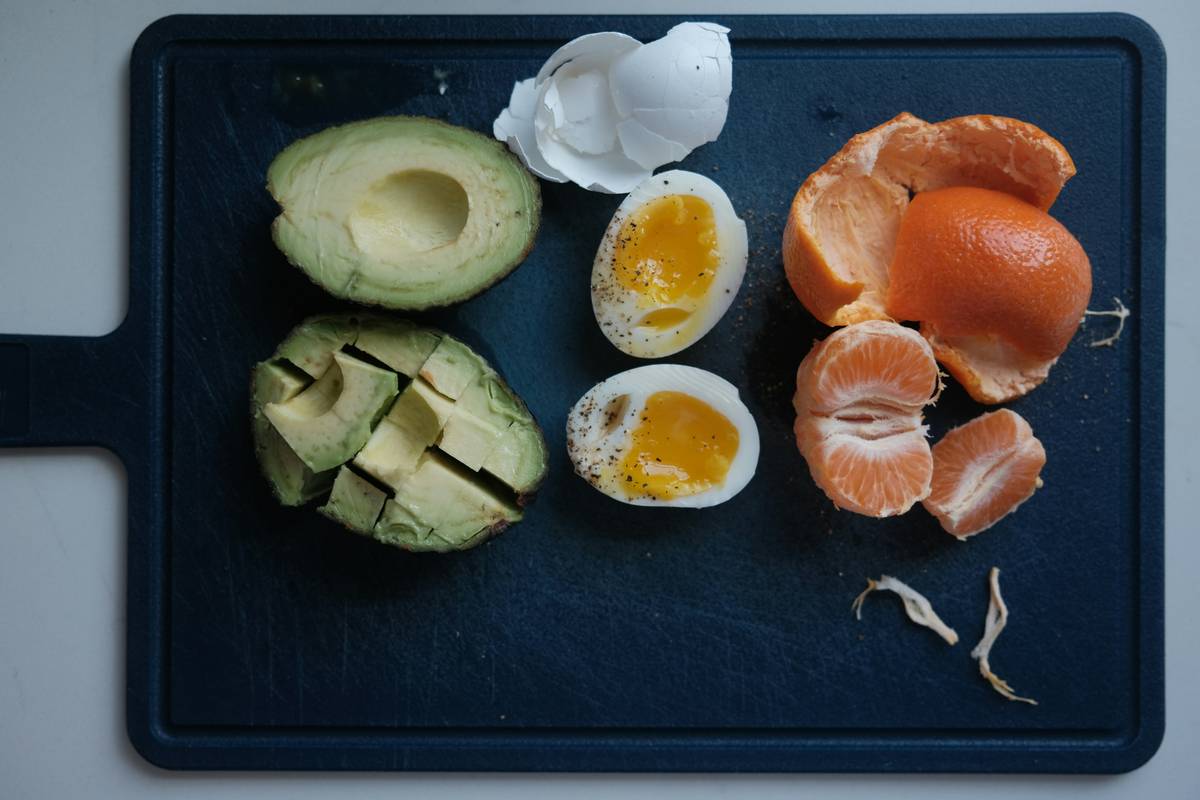Infographic showing top 5 testosterone-boosting foods vs. 5 testosterone-lowering foods with scientific references